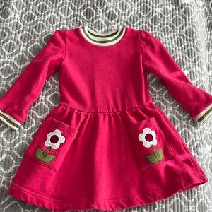 Mini Biden pink spring dress.